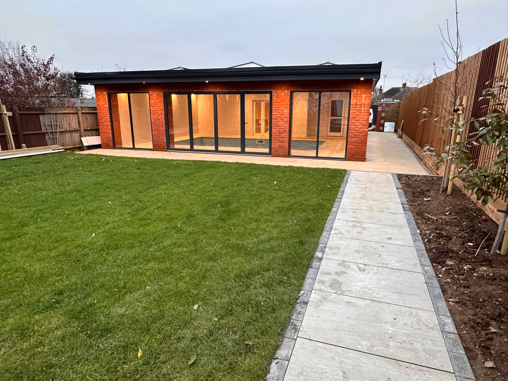 Completed exterior · Pool building and garden